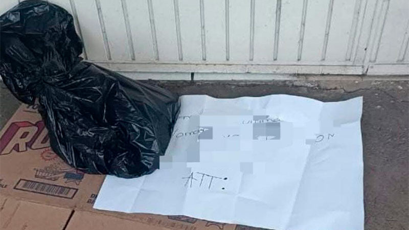 Hallan cabeza de cerdo dentro de una bolsa de plástico con un mensaje frente a prepa de Uruapan, Michoacán 